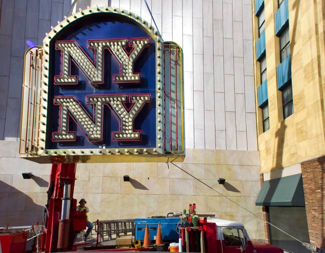 Yesco's Boyd Allen controls a crane with the New York - New York Hotel & Casino marquee entrance sign attached as it's taken down to be loaded on a flatbed and taken to the Neon Museum on Tuesday, Jan. 7, 2014.